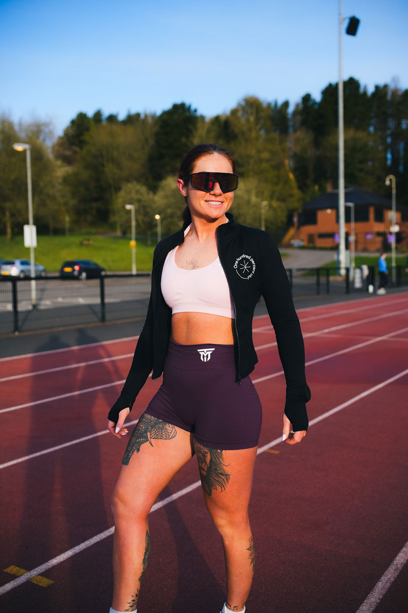 The coach is posing while wearing her sunglasses